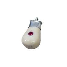 Load image into Gallery viewer, Tusk pear-shaped pendant with a red stone.
