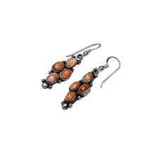 Load image into Gallery viewer, Pair of earrings with orange stones and sterling silver hooks.
