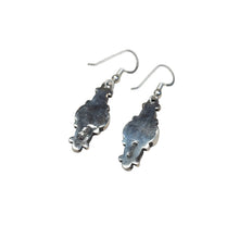 Load image into Gallery viewer, Back of a pair of earrings with orange stones and sterling silver hooks.
